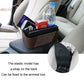 Brown car armrest storage box holding water bottle and phone; strap on back