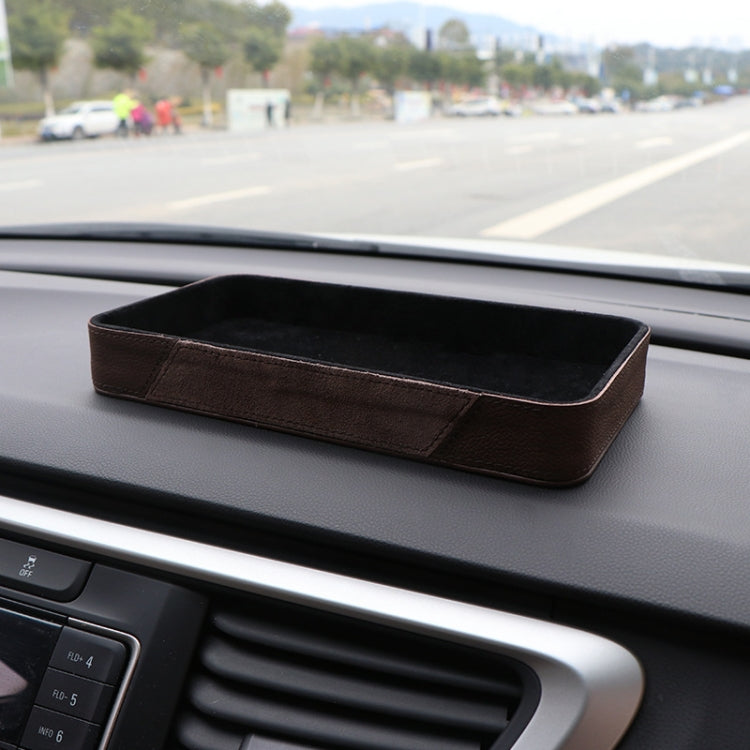 Brown dashboard storage box with black interior on car console
