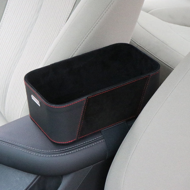 Black car armrest storage box with red trim and suede-style surface