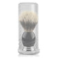 Transparent storage tube holding a beard brush, bristles inside and dark handle