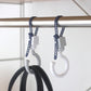 Two white stroller strap lock hooks with blue adjustable bands on rail