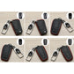 Set of black Toyota key fob covers with red stitching and metal keychain clips, multiple views