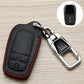 Black Toyota key fob cover with red stitching, metal clip and key ring, side view