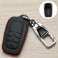 Black Toyota key fob cover with red stitching and metal keychain clip, side detail