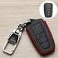 Black Toyota key fob cover with red stitching and metal keychain clip, embossed icons