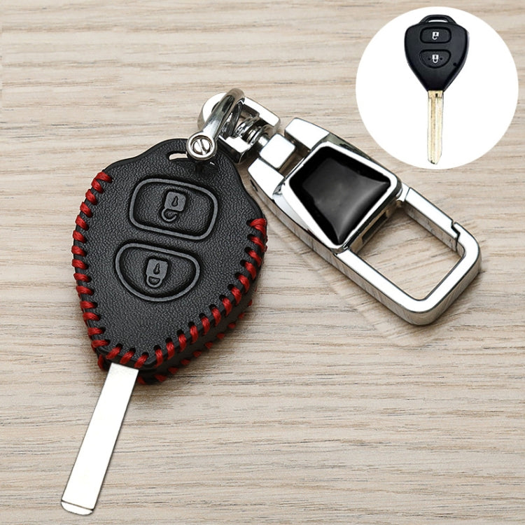 Black Toyota key fob cover with red stitching, metal clip and key blade, angled view