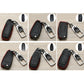 Set of black car key covers with red stitching, metal keyring and chrome key fob holder