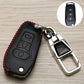 Black leather-style key fob cover with red stitched edge, embossed button panel, keyring
