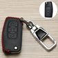 Black car key cover with red stitching and embossed icons, attached chrome key holder
