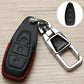 Black key fob cover with red stitching and embossed icon panel, chrome key holder
