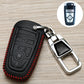 Black key fob cover with red stitched edge, embossed icons, attached chrome key holder