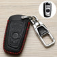 Black key fob cover with red stitched trim, VW-style emblem, and chrome metal keyring