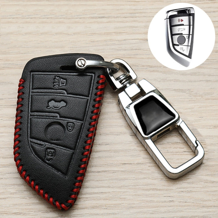 Black key fob cover with red stitched border, embossed icons, and chrome keyring clasp