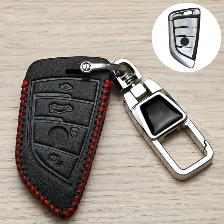 Black leather-style remote cover with red stitching, embossed symbol panel, and metal keyring