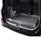 Black trunk protective pad with raised rim and smooth flat center in car