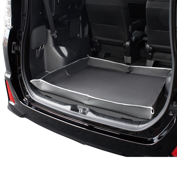 Black trunk protective pad with raised rim and smooth flat center in car