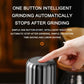 Automatic coffee grinder with finger pressing top button, silver body
