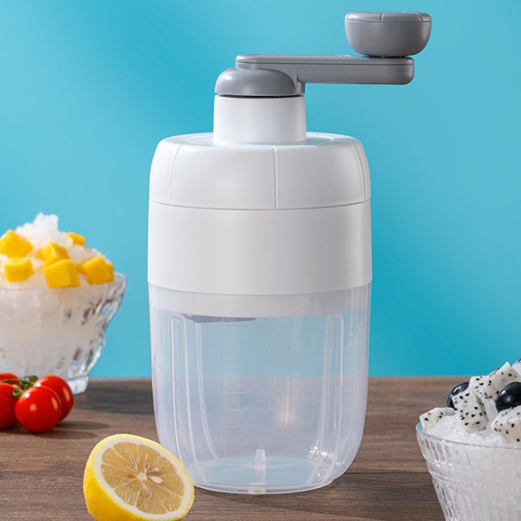 White manual ice shaver with gray handle and transparent collection cup for shaving ice.