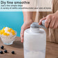 Hand-operated shaved ice maker with gray rocker handle on a clear ice collection container.