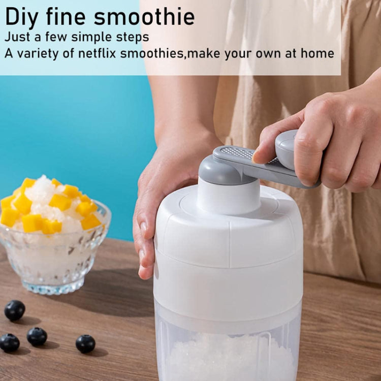 Hand-operated shaved ice maker with gray rocker handle on a clear ice collection container.