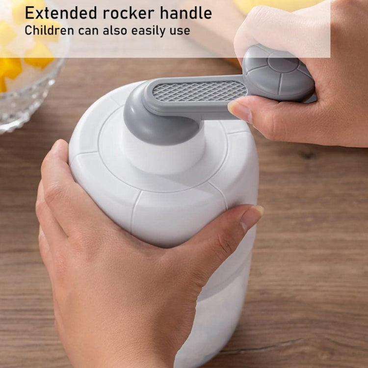 Shaved ice machine with extended rocker handle being pressed by a hand on the base.
