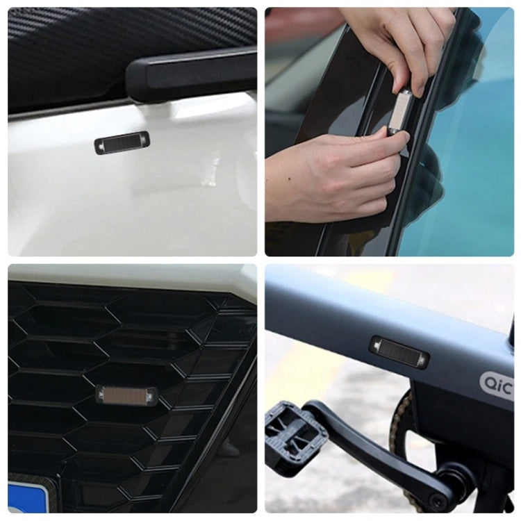 Mini solar warning light mounted on car body with adhesive-style placement