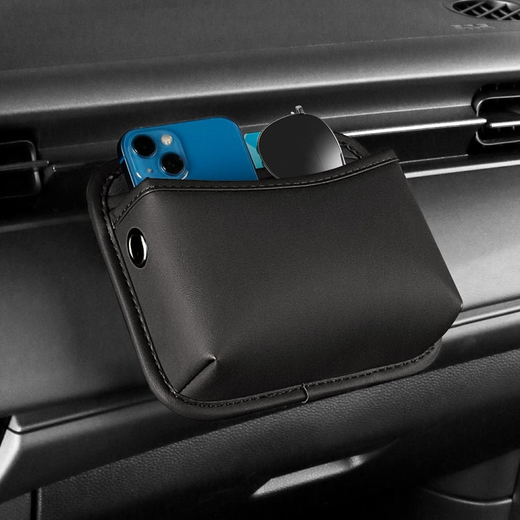 Black adhesive center console storage pouch mounted in car, with phone and key holder