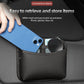 Black adhesive storage pouch with open top, holding a phone and small accessories
