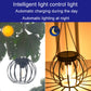 Small solar lantern light with black metal cage and hanging chain, daytime