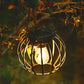 Warm-lit small black metal hanging solar lantern light with clear bulb