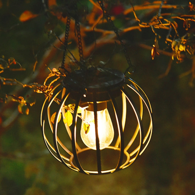 Warm-lit small black metal hanging solar lantern light with clear bulb