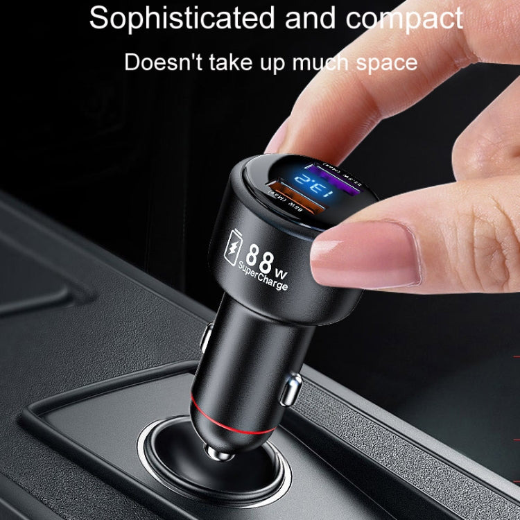 Compact black 88W car charger in hand, plug for cigarette lighter socket