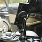 Black car cup holder wireless charging mount with phone attached and cable connected