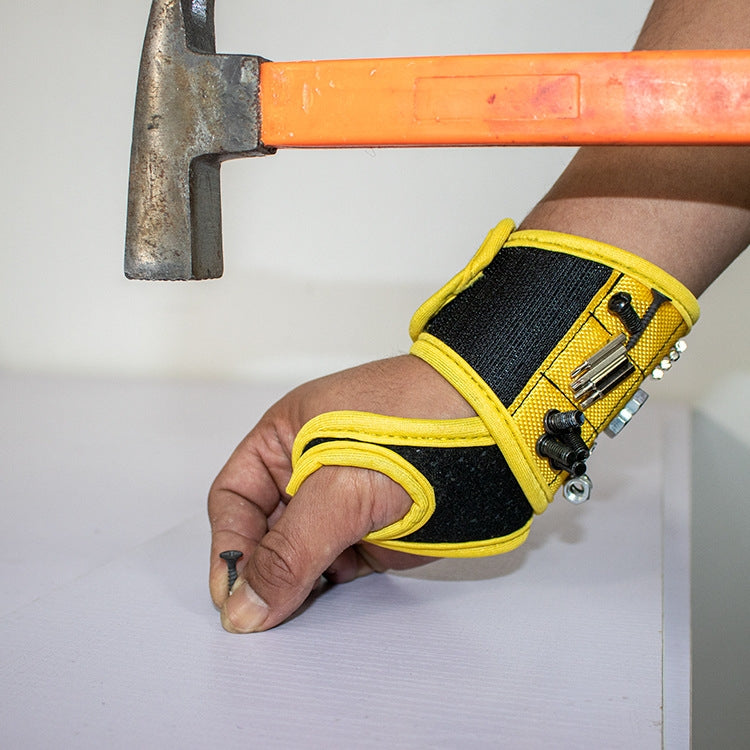 Yellow magnetic thumb wrap tool storage strap on arm with tools attached