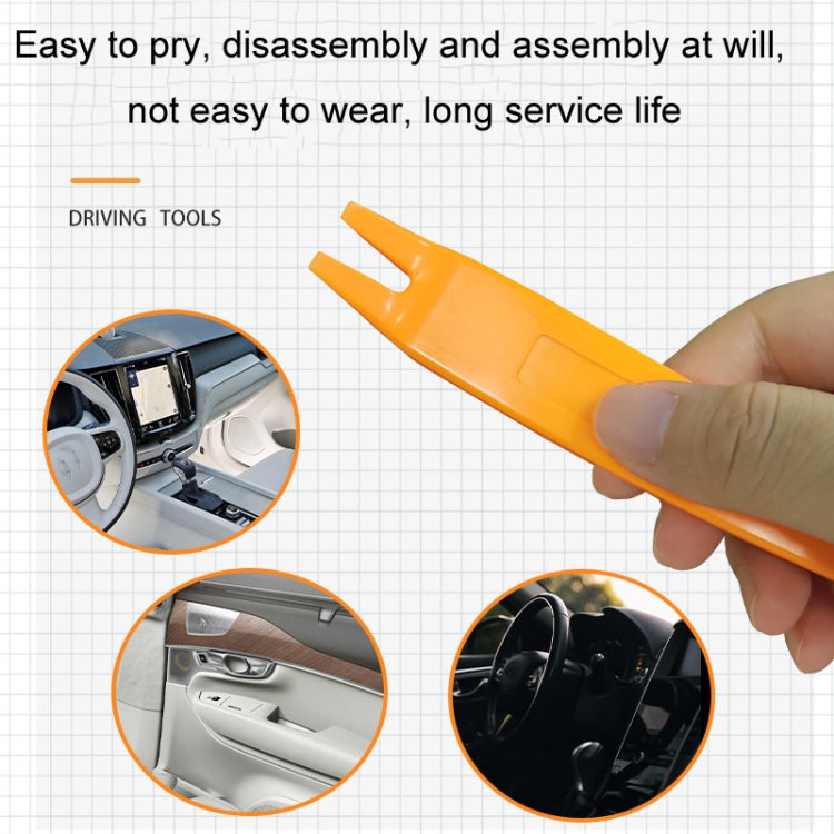 Orange car trim pry tool held in hand for panel disassembly