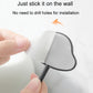 Adhesive wall hook with backing being peeled off, showing the mounting pad