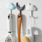 Three non-marking adhesive wall hooks in blue, gray, and white