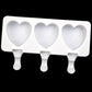White 3-cavity heart ice pop mold tray with three stick-shaped handles