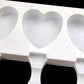 Close-up of heart cavity ice pop mold tray with three hinged handle sections