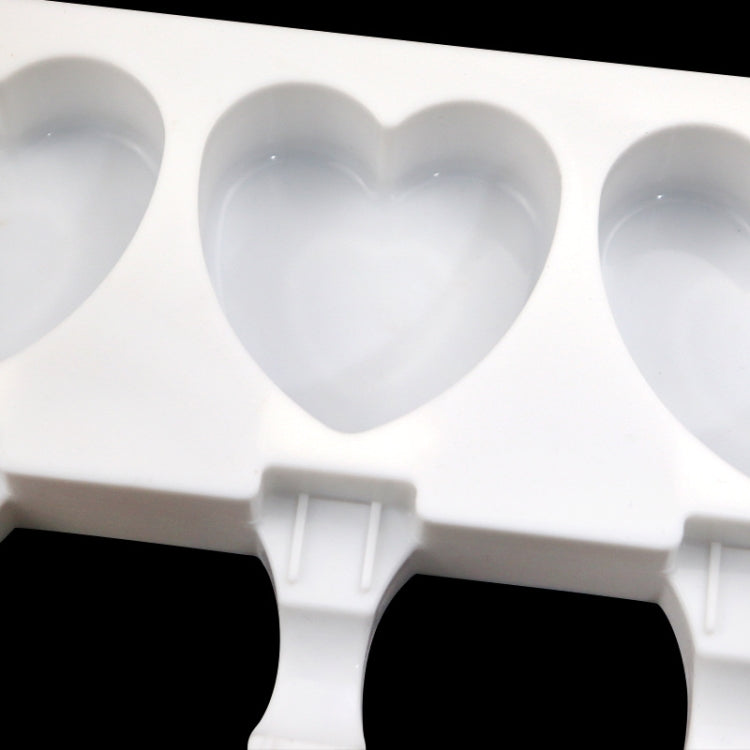 Close-up of heart cavity ice pop mold tray with three hinged handle sections