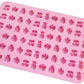 Pink silicone candy mold sheet with fruit, shell, and heart-shaped cavity pattern