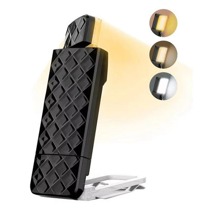 Clip-on book reading light with textured black body and warm LED glow