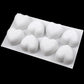 Silicone heart mold with eight white heart-shaped pieces in cavities
