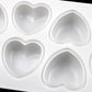 Close-up of silicone heart cavities on white rectangular mold tray