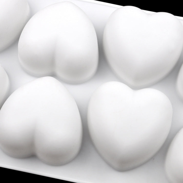 Silicone heart mold filled with four white heart-shaped pieces