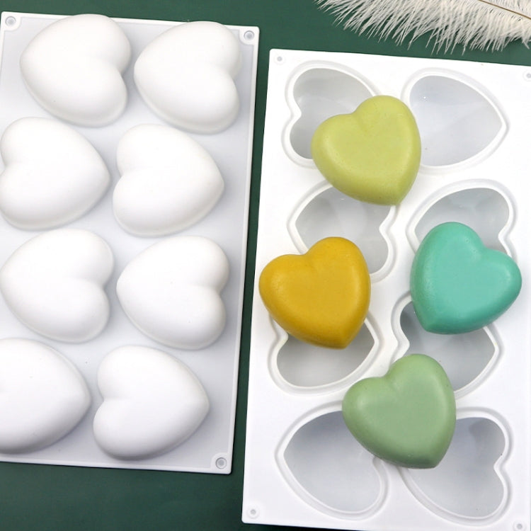 Silicone heart mold with eight cavities filled with colored heart soaps
