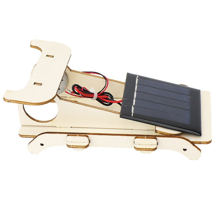 Wooden solar car kit side view showing solar panel, red wiring, and motor module