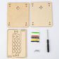 Wood science kit panels with circuit-style cutouts, thread spools, small screwdriver