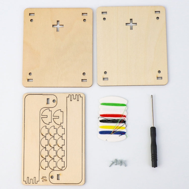 Wood science kit panels with circuit-style cutouts, thread spools, small screwdriver