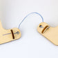 Wooden balance frame pieces with blue string loop and metal pin inserts